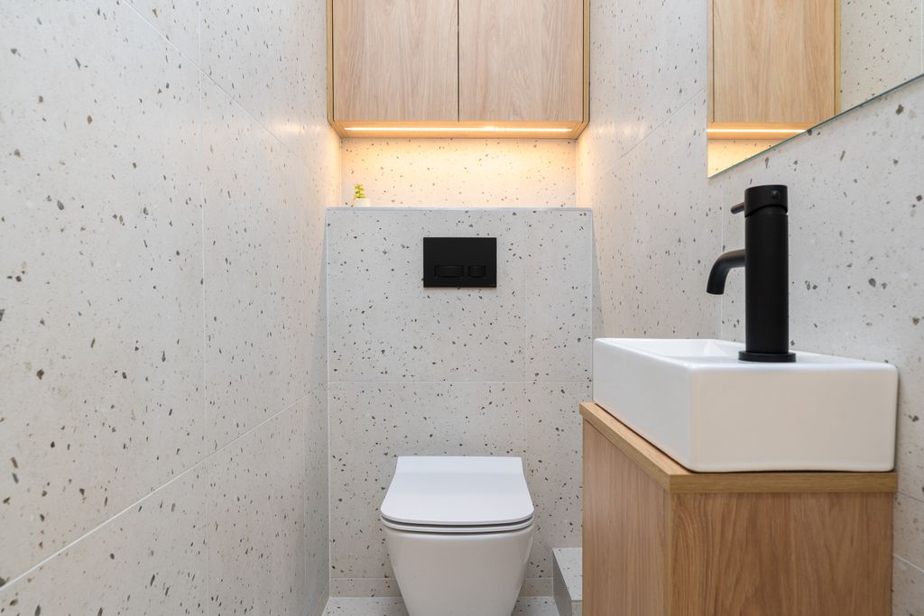 Elegant minimalist bathroom with modern fixtures in Kraków, Poland.