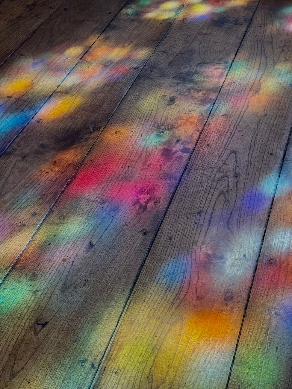 colorful light reflections on wooden floor